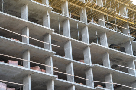 Stage of construction of a modern residential multi-storey building. Concrete monolith. Brick building under construction. Real estate.の写真素材