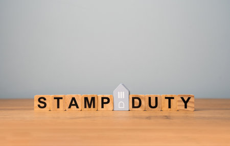 Stamp duty concept. Taxes assessed during the transfer of real estate between two parties. Buying housing and land. Property. Stamp Duty Land Tax SDLT. Wooden blocksの写真素材