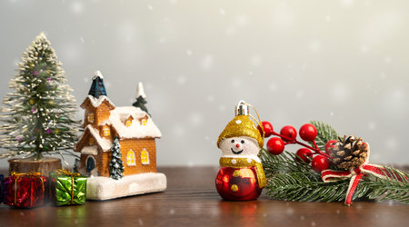 New Year's toy, house, xmas tree and gifts. Concept of celebrating Christmas holiday and festive atmosphere. Snowfallの写真素材