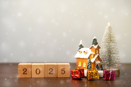 Wooden blocks, Christmas tree and gifts with houses. Merry Christmas and Happy New Year! Xmas concept. Festive winter holiday. Snowfallの写真素材