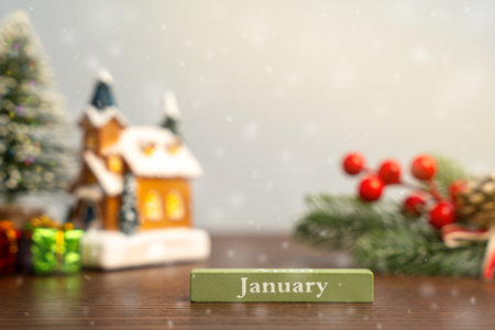 January block against the background of a Christmas tree and a house with snow. Concept of the beginning of a new winter seasonの写真素材