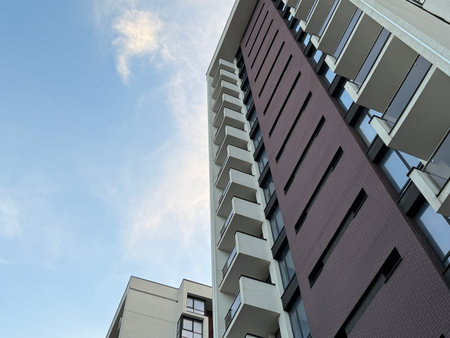 View of multi-storey buildings in a modern residential complex on a sunny day a blue sky background. Skyscrapers and real estateの写真素材