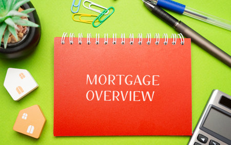 Mortgage overview concept. Summary of the key terms of a home loan, including the loan amount, interest rate, repayment schedule and term length. Inscription on a notepad and calculator with pensの写真素材