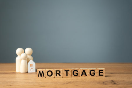 Loan and credit interest rate. Apartments, housing and house. Real estate market analysis concept. Business and finance. Wooden blocks with the words Mortgage and family with house.の写真素材