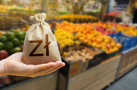 zloty money bag on the background of a grocery store counter with fresh organic vegetables and fruits. Concept of cost of goods and food products. Grocery set. Import and exportの写真素材