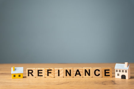 Wooden blocks with the words Refinance and miniature houses. Real estate concept. Business and finance. Mortgage, loan. Interest rates. Home lendingの写真素材