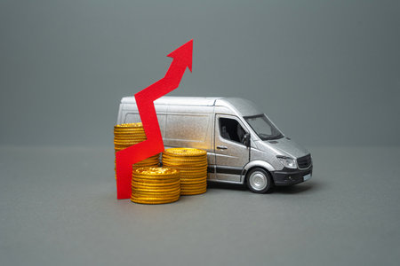 Delivery van with money coins and up arrow. Increased profit, more transportation. Investment. Tax receipt. Increased shipments boost company earnings. Expanding business activity.の写真素材