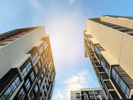 View of multi-storey buildings in a modern residential complex on a sunny day a blue sky background. Skyscrapers and real estateの写真素材