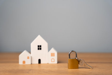 Padlock and wooden houses. Security concept. Insurance. Security and alarm systems, video surveillance, motion and burglary sensors.の写真素材