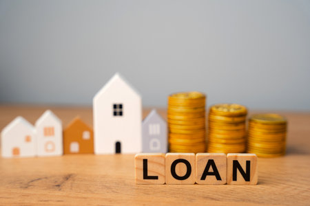 Wooden blocks Loan and houses. Financial agreement in which a lender provides money or assets to a borrower with the expectation of repayment over time with added interest. Real estate conceptの写真素材