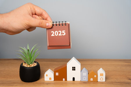 Notes 2025 and houses. Family budget planning for next year. Investments, plans, savings. Mortgage rates. Real estate concept. Refinance homeの写真素材