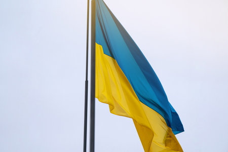Ukraine flag, national symbol fluttering in blue sky. Large yellow blue Ukrainian state flagの写真素材