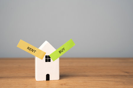 Real estate concept. Renting apartment. Rental home. Buying or purchasing housing. Make the right decision. Wooden houses with the words rent or buyの写真素材
