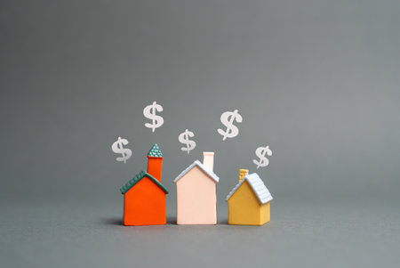 House figures and dollar symbols. Buying and selling real estate. Rent. Market trends, housing prices, mortgage rates, and investment opportunities influence the property sector and financial planningの写真素材