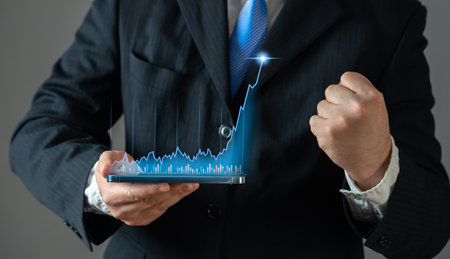 Businessman rejoices in high growth of income and value of trading stocks or cryptocurrency. Concept of success in business. Rising profits, stock market gains, and cryptocurrency value appreciation.の写真素材