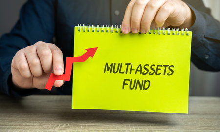 Multi-assets fund concept. Investment fund that allocates its portfolio across a diverse range of asset classes, such as stocks, bonds, real estate, and commodities. Notebook and arrow in male handsの写真素材