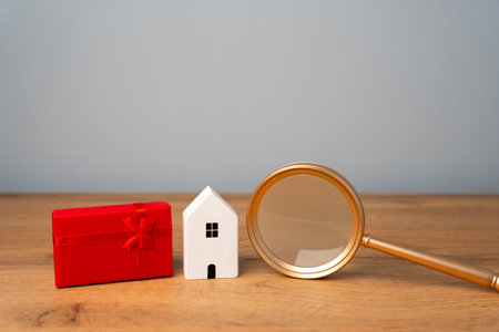 Miniature house and gift box. Housing as a gift. Win an apartment in the lottery. To inherit property. Holiday discounts. Buying an apartment at a low price. Sale of real estate. Presentの写真素材