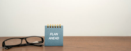Plan ahead notes and glasses. Process of organizing and preparing for future tasks, events, or goals in advance. Concept business organizationの写真素材