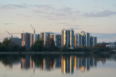 Beautiful view of the city lake with Multi-storey buildings with apartments. New residential complex and new buildings. City district. Real estate concept. Ivano-Frankivsk, Ukraine - October 28, 2024.の写真素材