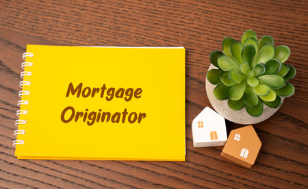 Financial professional or institution that works with borrowers to initiate the process of obtaining a mortgage loan. Notes mortgage originator and housesの写真素材