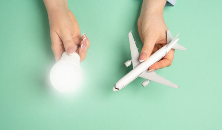 Light bulb idea and airline passenger plane. Innovative ideas in aviation. Efficient flight planning, business strategies in the travel industry. New travel solutions, airline improvements.の写真素材