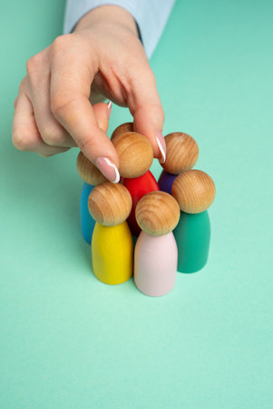 The hand selects one human figure from the group.の写真素材