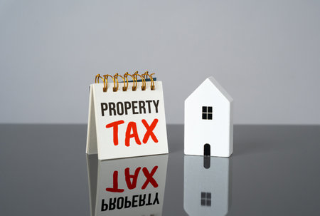Property tax and house figure. Balancing property value and taxation. Deadlines and terms. Tax write-off.の写真素材