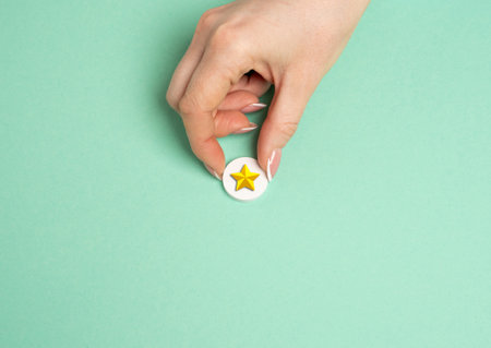 The hand holds a gold star. Distinction. Rating and recognition. Achievement. Top ratings in...