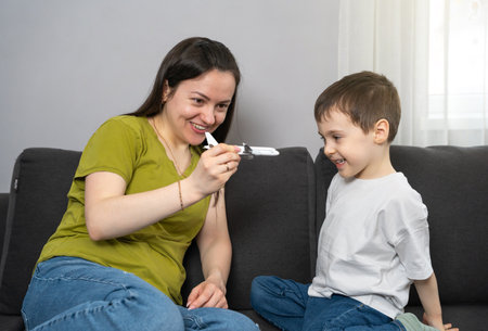 Mom and boy play with a passenger plane. Wish to go on a journey. Prepare the child for the first flight. Excitement for travel and new experiences.の写真素材
