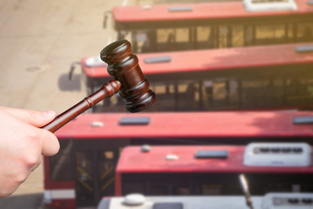 Judge's gavel and buses in the background. Traffic and driving rules concept. City transport, Auto accident, drunk driving, court of law, justiceの写真素材