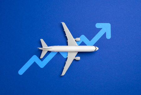 Passenger plane and arrow up. Concept of growth of flights, passenger flow. Hot season. Increase of cost of tickets, fuel, service of flight personnel. Airline industry, travel economicsの写真素材