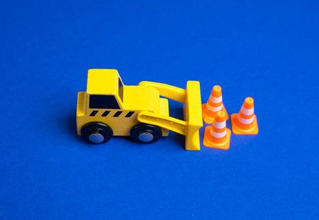 A yellow bulldozer moves traffic cones. The concept of establishing or removing restrictions....