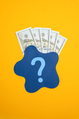 Dollar bills behind blue spot. Concept of dirty money or its unclear origin. Legalization of money, money laundering. Financial transparency, illegal transactions. Financial investigations.の写真素材