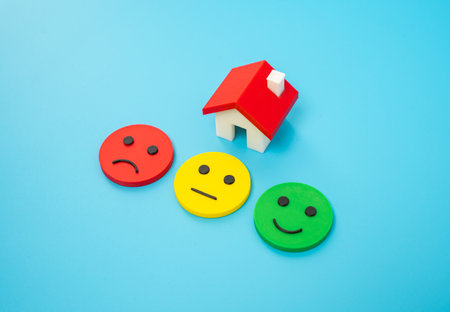 House and three mood emojis. Housing evaluation. Rent and booking. Reviews and feedback. Property evaluation, booking platforms, rental satisfaction, or user-generated housing ratings.の写真素材