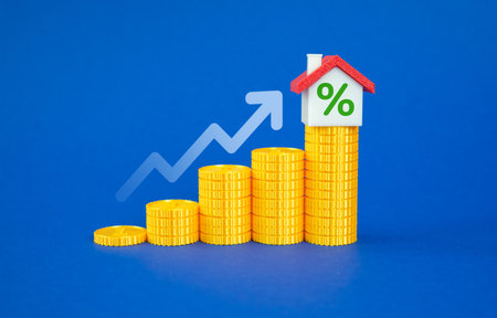 House with percentage on top of stacks of coins. Real estate appreciation and return on investment. Profit from investment. Profitable property ownership.の写真素材