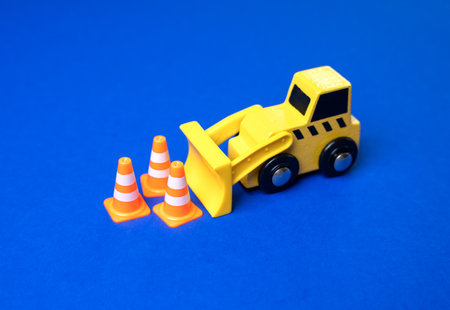 A bulldozer pushes traffic cones. Concept of placing restrictions and regulations. New rules. Construction and zoning.の写真素材