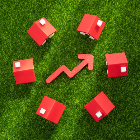Houses on the grass and a red arrow pointing up. Rising housing prices, market growth, or increased demand for suburban living. Real estate appreciation, urban expansion, property value.の写真素材