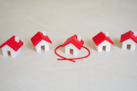 The house is outlined in red among others. Select from the options. Selection process in real estate, market comparison, or home preferences.の写真素材