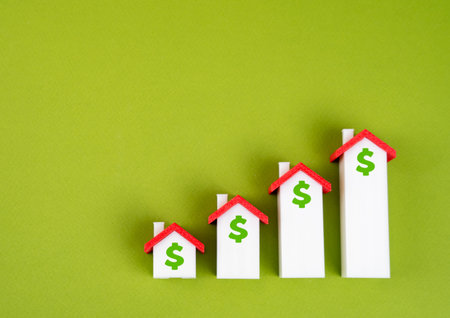 Houses in the form of a graph of housing price growth. Rising property prices, touching on housing inflation, affordability crisis, or market speculation in real estate investment.の写真素材