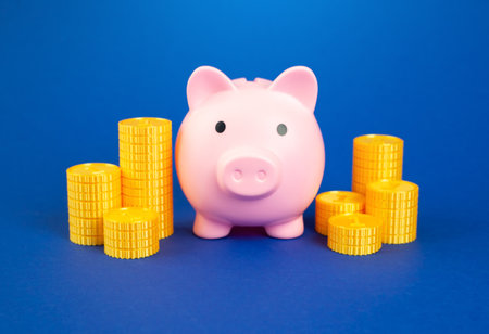 Piggy bank surrounded by money coins. Savings and deposits. Wealth accumulation and financial planning. Income strategies, budgeting. Economic habits.の写真素材