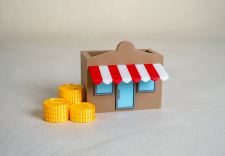 A store and a stack of money coins. Commercial real estate. Start your own business. Lending and accounting services. Franchise. Entrepreneurship, small business financing, shop ownershipの写真素材