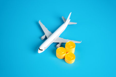 Passenger plane and stacks of coins. Finance in the airline industry. Profits, income and taxation. Investments and expenses. Aviation revenue, investment, operational costs, and profitability.の写真素材