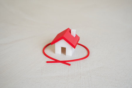 The house is outlined in red. Choice of housing. Property valuation. Real estate assessments, housing choices, or buyer processes.の写真素材