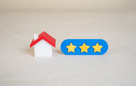 The house has a three star rating. Feedback systems, real estate comparison tools, or service evaluation. Average satisfaction level or moderate property qualityの写真素材