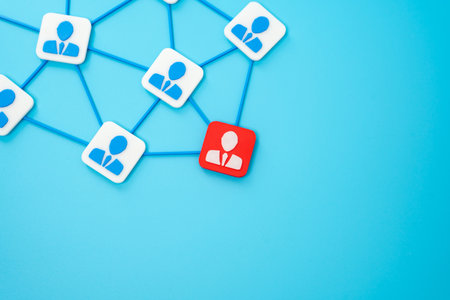 Corporate network and red figurine of an employee. Threat of being laid off. Fear of job loss,...