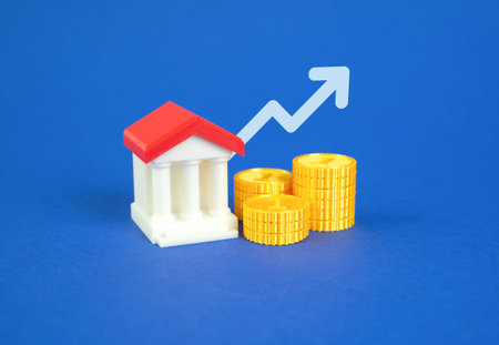Bank building with money and an arrow pointing up. Bank income growth. High liquidity and capitalization. Increased profits, stable liquidity, and strong capital performance. Macroeconomic recoveryの写真素材