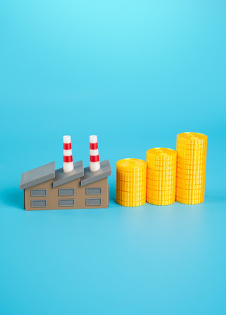 Industrial plant and growing stack of money coins. Increase in income and orders. Increase in wages of workers in factories. Positive impact of government subsidies and contracts.の写真素材