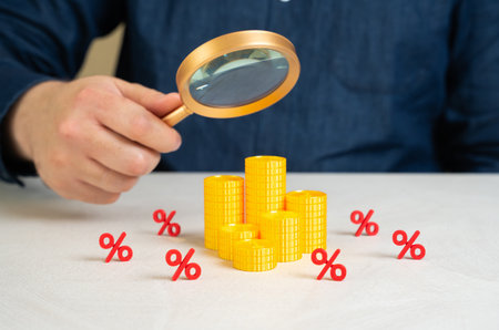 A man studies the financial market with all its costs, taxes and fees. Complexity of investment planning, budget awareness. Hidden pitfalls of financial systems, interest traps to service charges.の写真素材