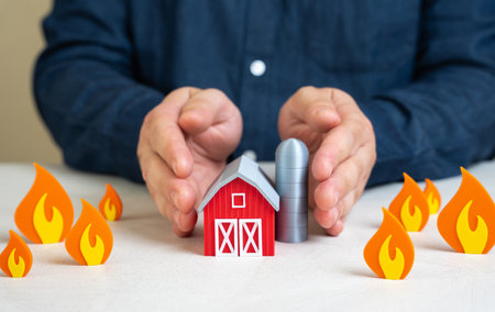 A man protects a farm from fire. Safety in difficult climate conditions. Droughts and fires. Saving agricultural crops. Emergency preparedness, crop insurance. Environmental challengesの写真素材