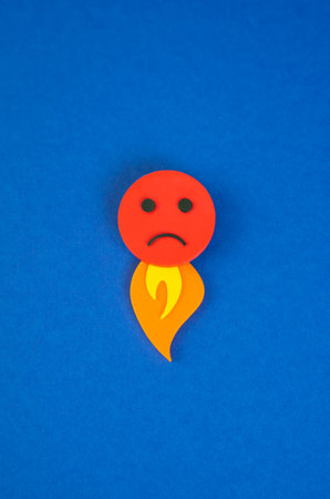 An evil face with a flame of fire coming out from below. The concept of rage and uncontrollable anger. Uncontrolled emotion, social outrage, or backlash. Psychological burnoutの写真素材